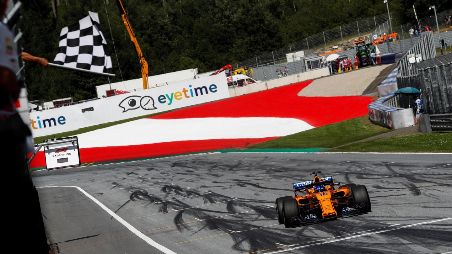 Fernando Alonso (ESP) McLaren MCL33 takes the chequered flag at Formula One World Championship,