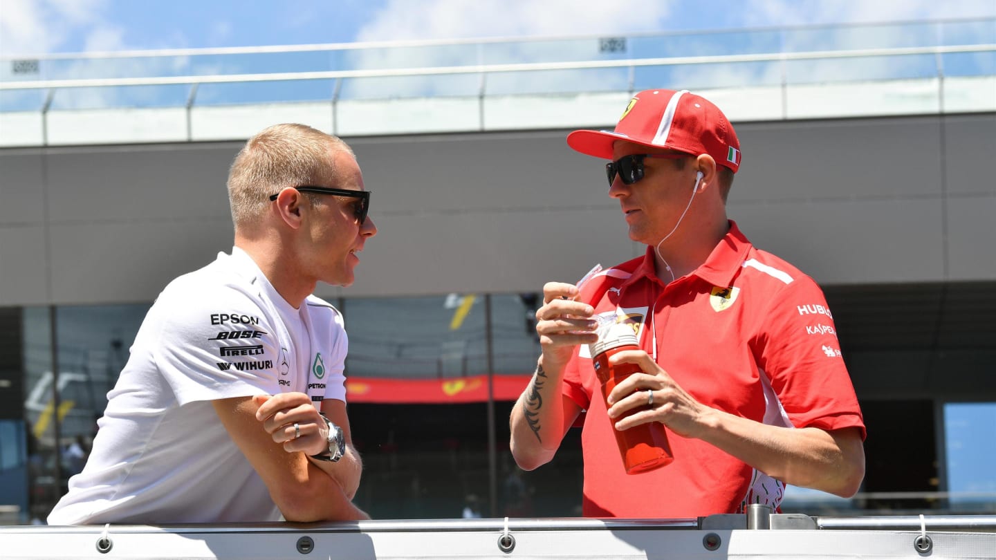 Valtteri Bottas (FIN) Mercedes-AMG F1 and Kimi Raikkonen (FIN) Ferrari on the drivers parade at