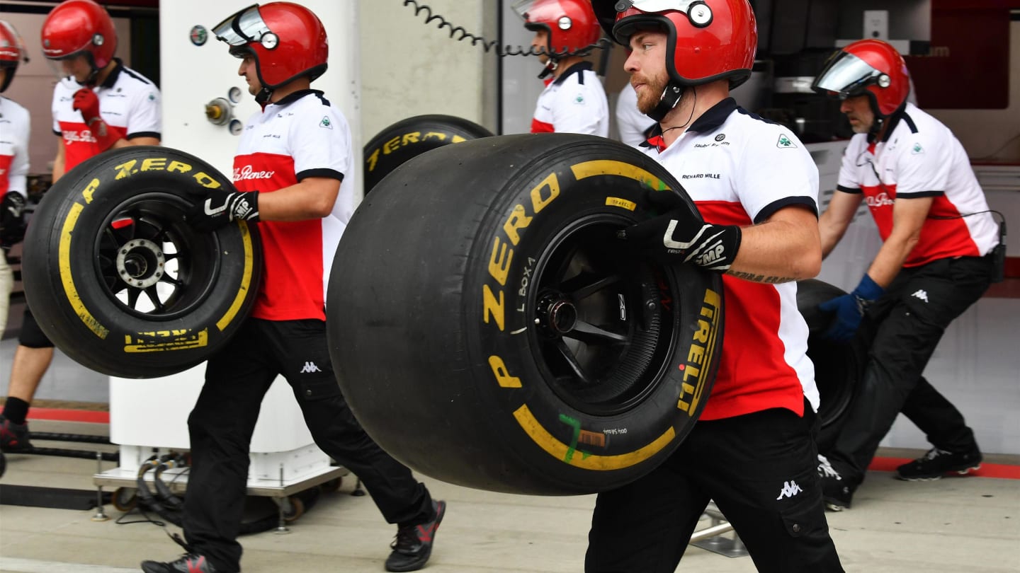 Alfa Romeo Sauber F1 Team mechanics with Pirelli tyres at Formula One World Championship, Rd9,