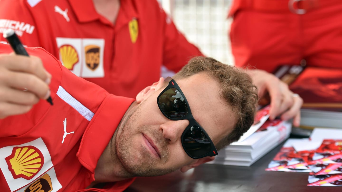 Sebastian Vettel (GER) Ferrari at the autograph session at Formula One World Championship, Rd2, Bahrain Grand Prix, Race, Bahrain International Circuit, Sakhir, Bahrain, Sunday 8 April 2018. © Simon Galloway/Sutton Images