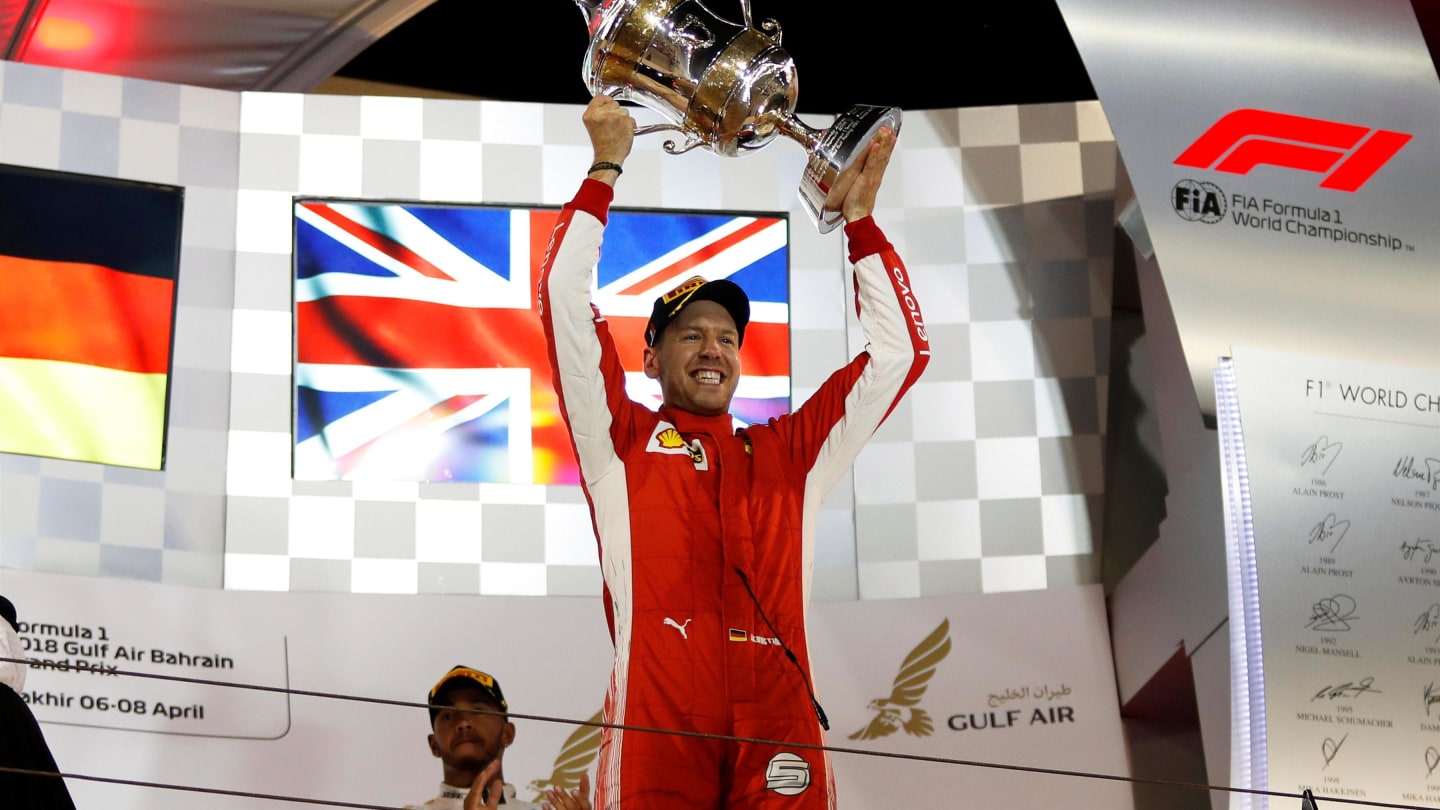 Race winner Sebastian Vettel (GER) Ferrari celebrates on the podium with the trophy at Formula One World Championship, Rd2, Bahrain Grand Prix, Race, Bahrain International Circuit, Sakhir, Bahrain, Sunday 8 April 2018. © Manuel Goria/Sutton Images