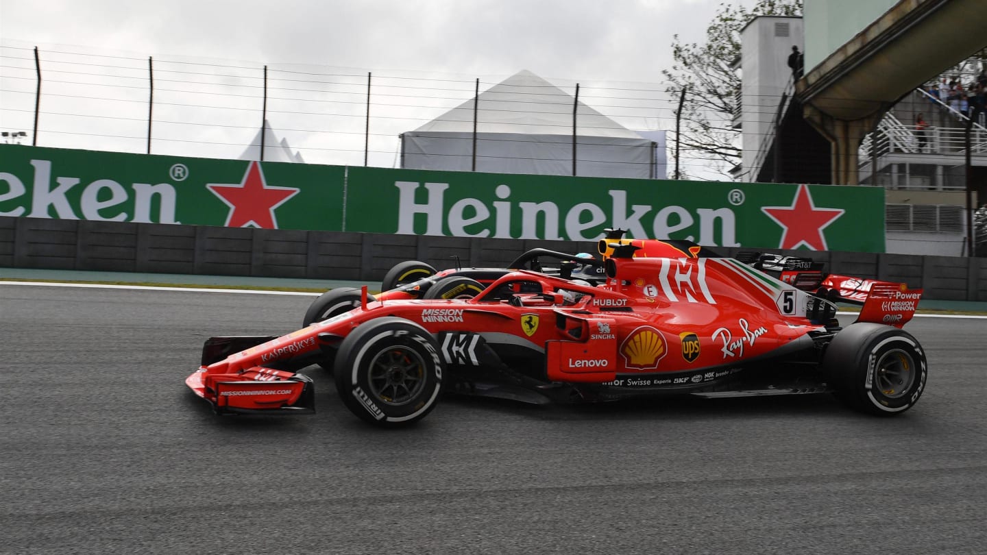 Sebastian Vettel, Ferrari SF71H and Daniel Ricciardo, Red Bull Racing RB14 battle at Formula One