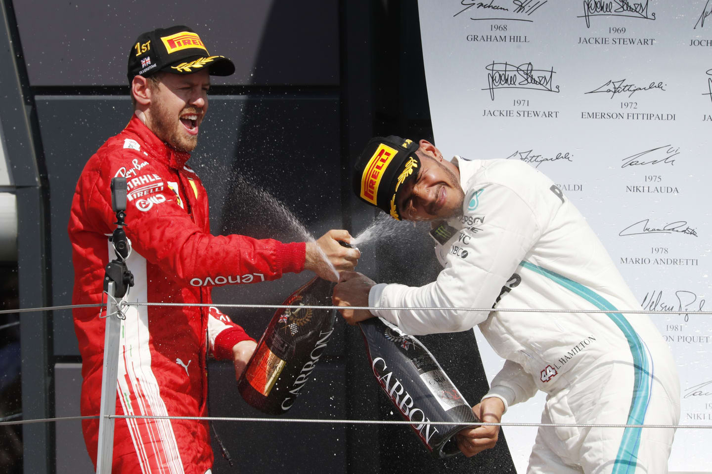 Sebastian Vettel (GER) Ferrari and Lewis Hamilton (GBR) Mercedes-AMG F1 celebrate on the podium with the champagne at Formula One World Championship, Rd10, British Grand Prix, Race, Silverstone, England, Sunday 8 July 2018. © Manuel Goria/Sutton Images