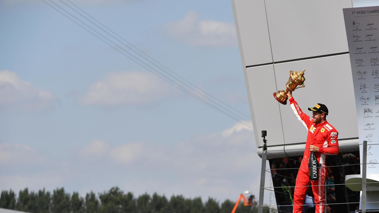 Race winner Sebastian Vettel (GER) Ferrari celebrates on the podium with the trophy at Formula One World Championship, Rd10, British Grand Prix, Race, Silverstone, England, Sunday 8 July 2018. © Mark Sutton/Sutton Images