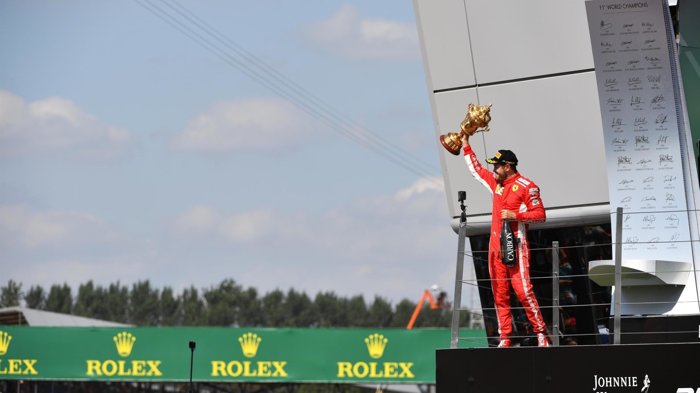 Race winner Sebastian Vettel (GER) Ferrari celebrates on the podium with the trophy at Formula One World Championship, Rd10, British Grand Prix, Race, Silverstone, England, Sunday 8 July 2018. © Mark Sutton/Sutton Images