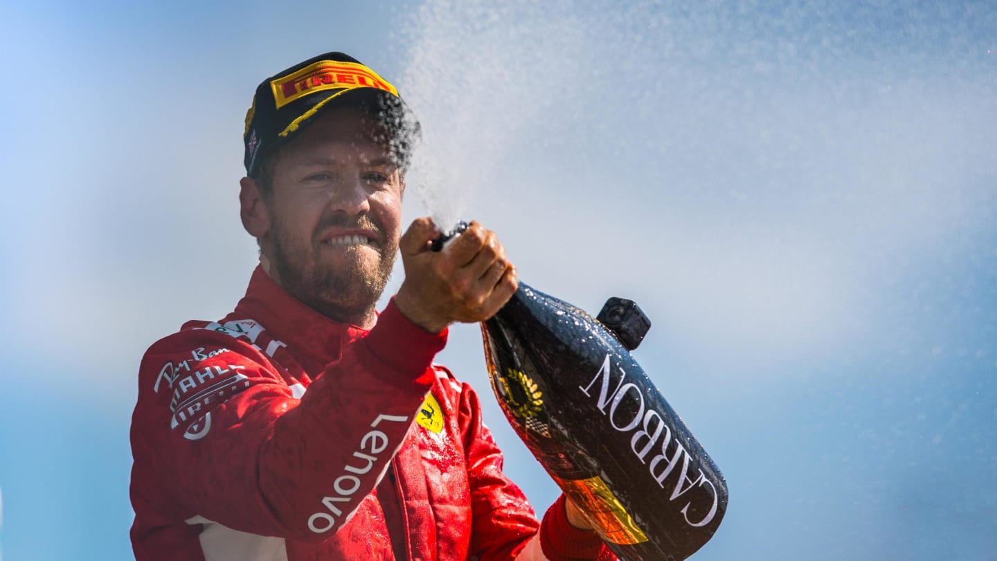 Race winner Sebastian Vettel (GER) Ferrari celebrates on the podium with the champagne at Formula