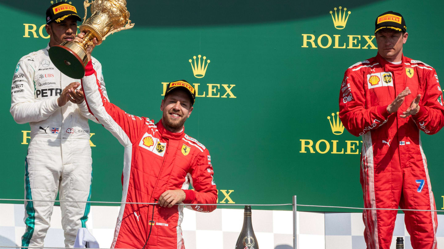 Sebastian Vettel (GER) Ferrari celebrates on the podium with the trophy at Formula One World