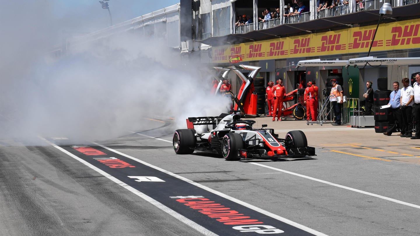 Romain Grosjean (FRA) Haas VF-18 smokes in pit lane in Q1 at Formula One World Championship, Rd7,