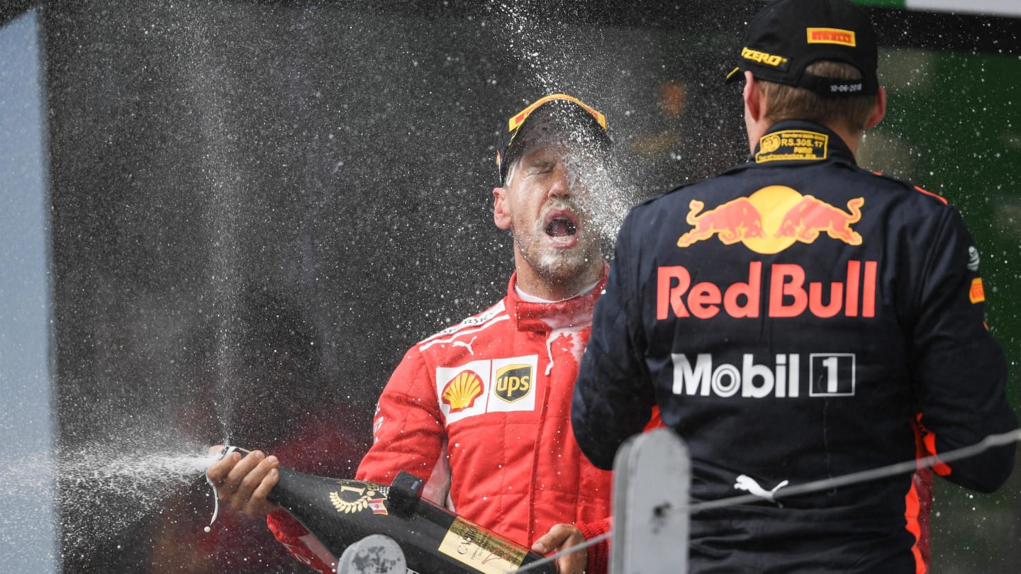 Race winner Vettel (GER) Ferrari and Verstappen (NED) Red Bull Racing celebrate on the podium with the champagne at Formula One World Championship, Rd7, Canadian Grand Prix, Race, Montreal, Canada, Sunday10 June 2018. © Simon Galloway/Sutton Images