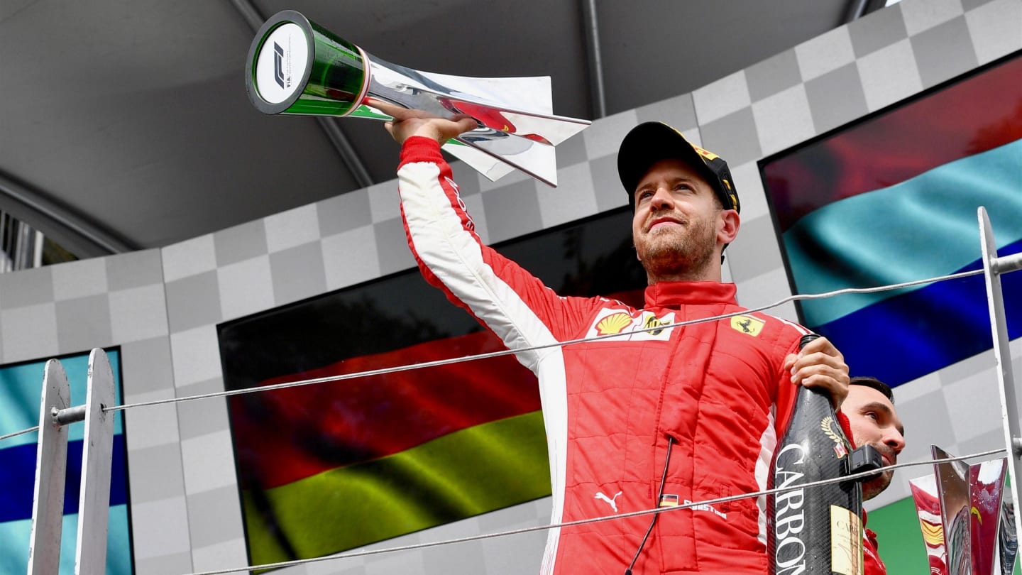 Race winner Sebastian Vettel (GER) Ferrari celebrates with the trophy on the podium at Formula One