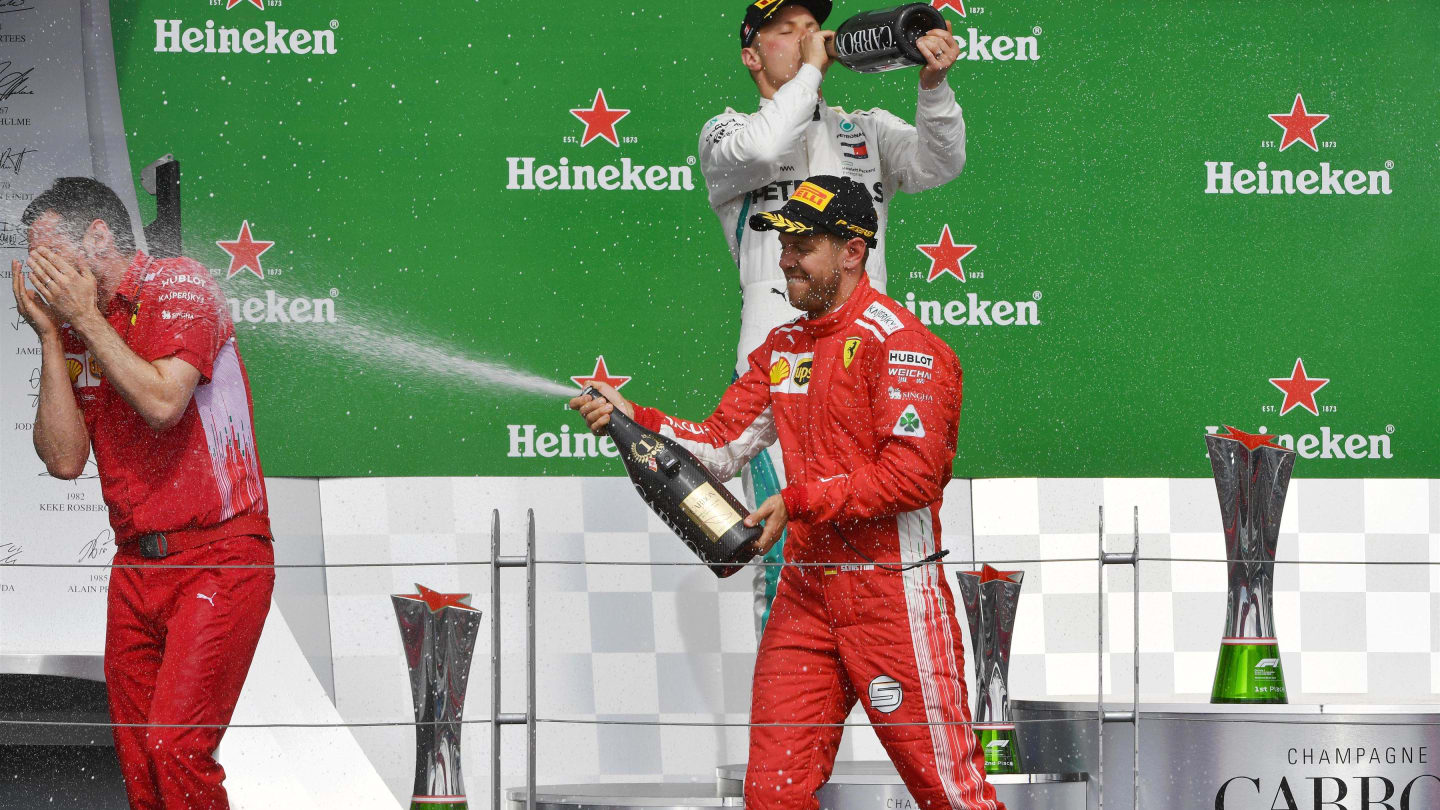 Race winner Sebastian Vettel (GER) Ferrari celebrates on the podium with the chmpagne at Formula