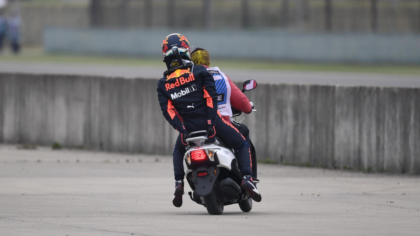 Daniel Ricciardo (AUS) Red Bull Racing stopped on track in FP3 and catches a lift on a scooter at
