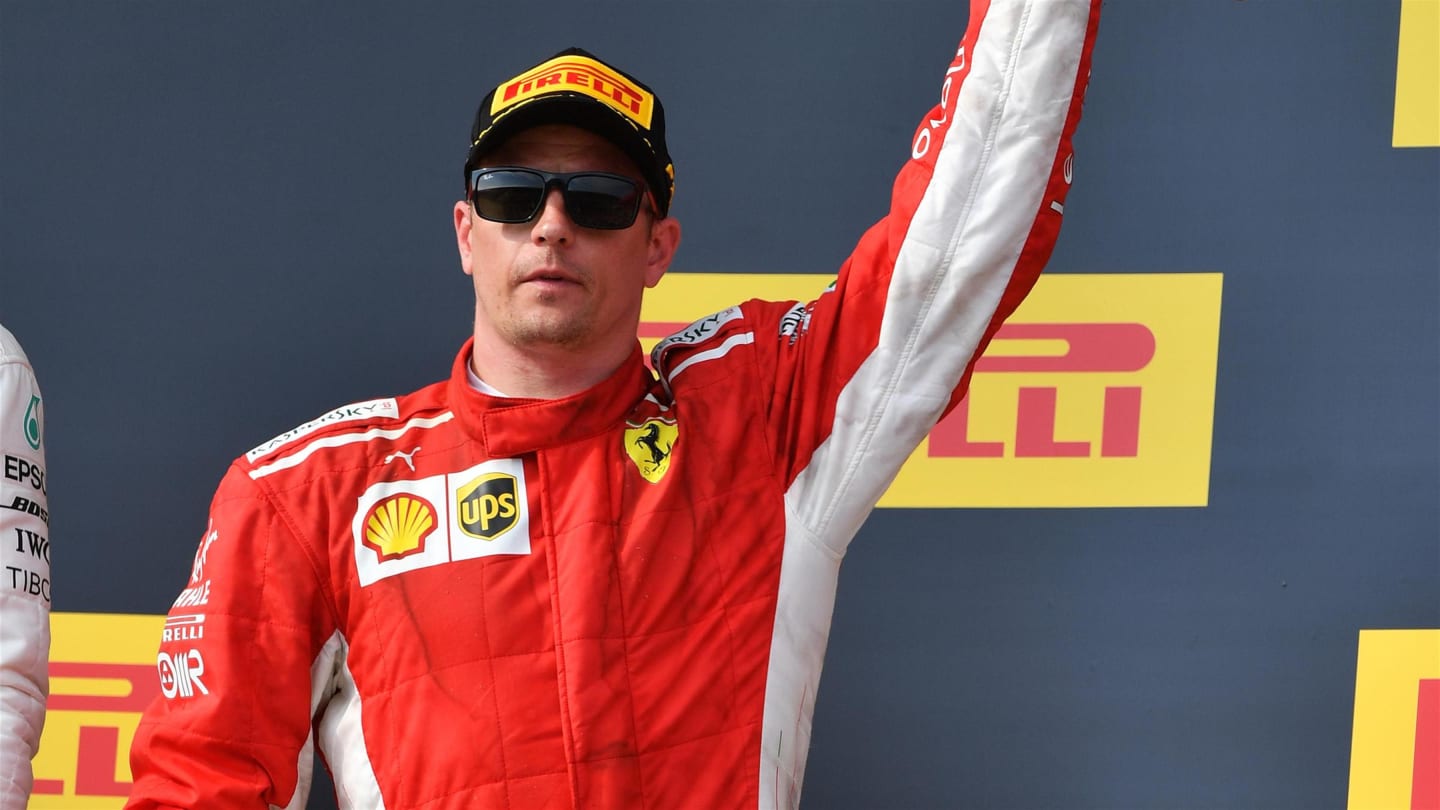 Kimi Raikkonen (FIN) Ferrari celebrates on the podium with the trophy at Formula One World