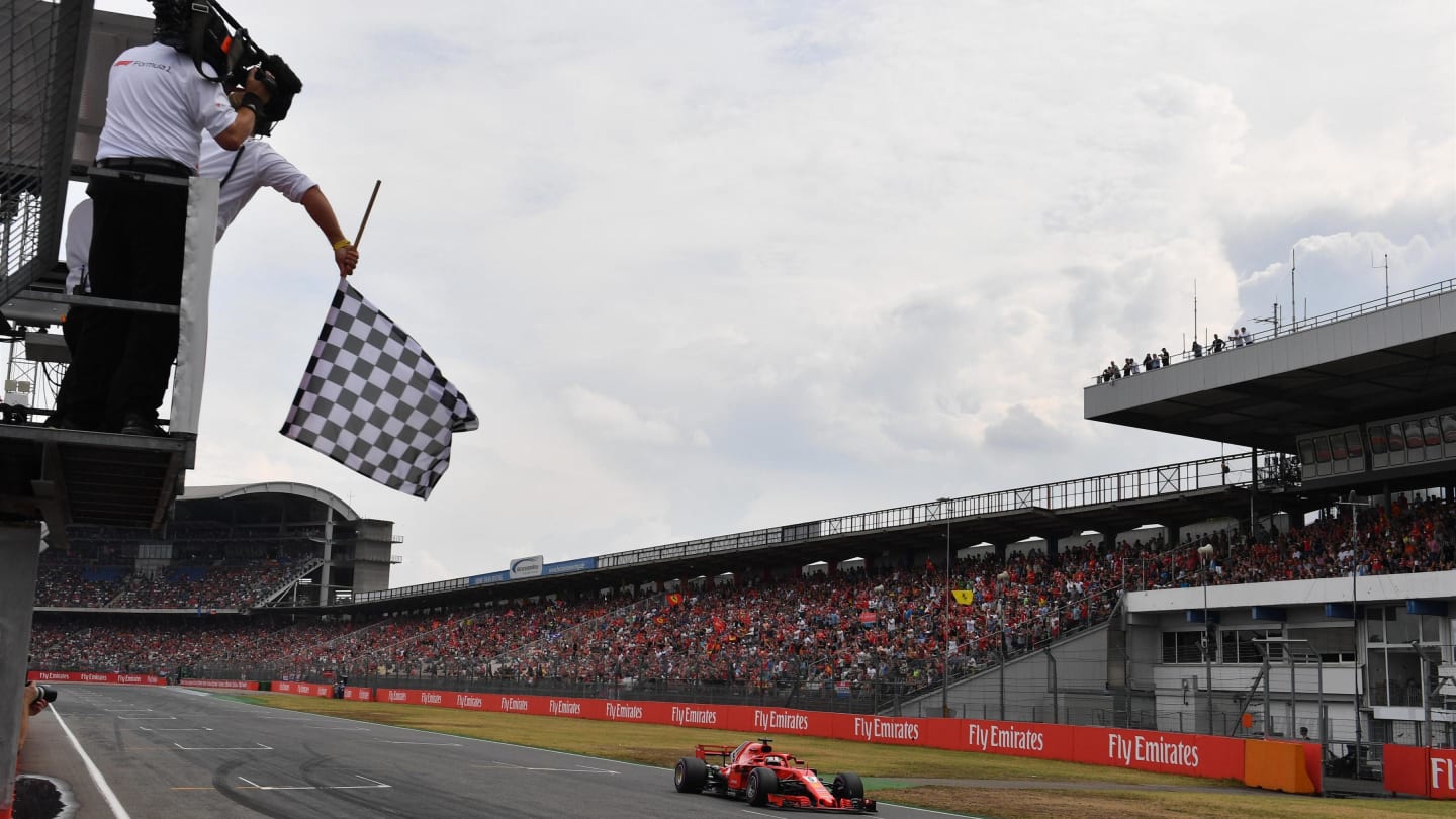 Pole sitter Sebastian Vettel (GER) Ferrari SF-71H takes the chequered flag at the end of Qualifying
