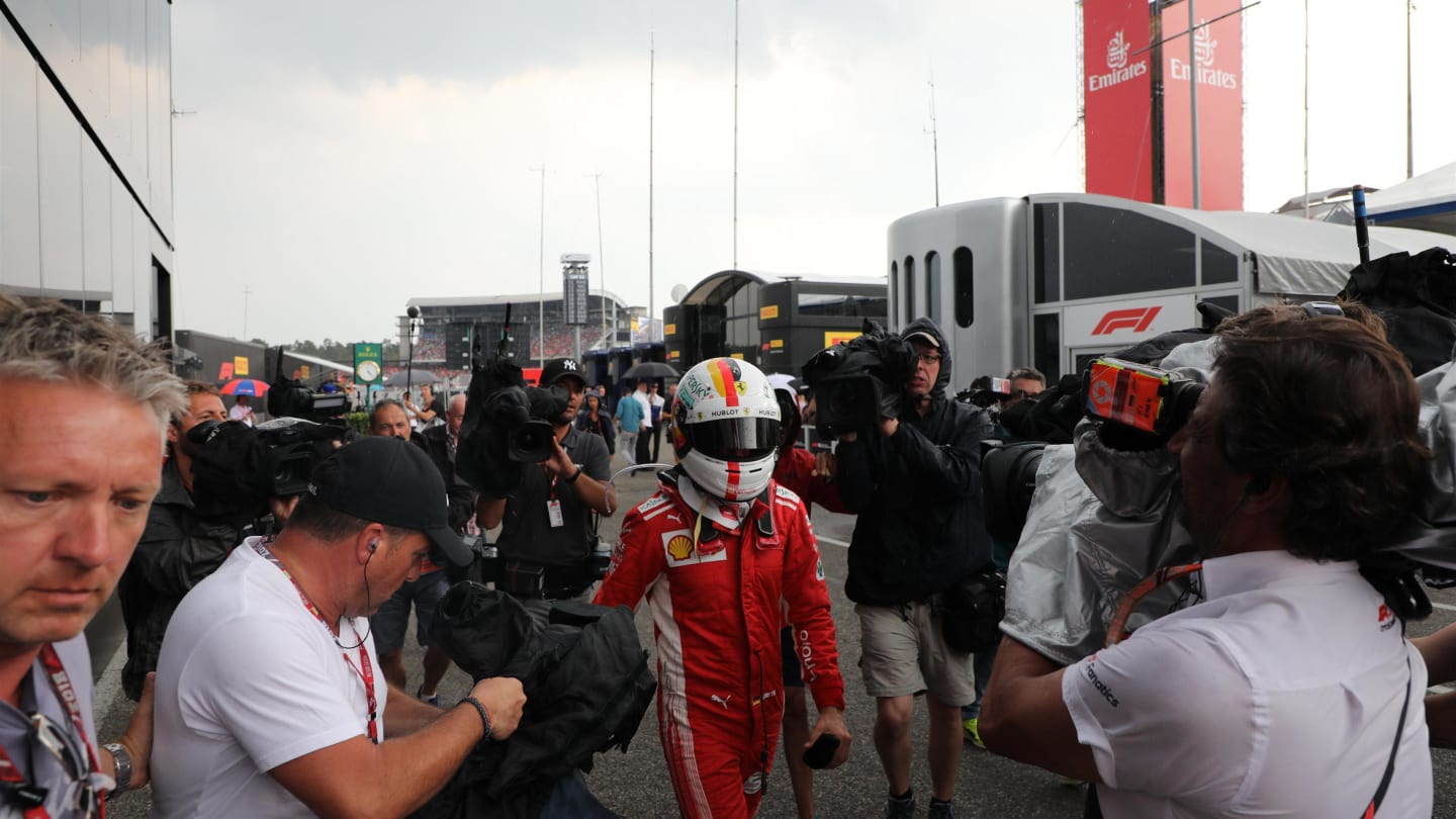 Sebastian Vettel (GER) Ferrari walks in after crashing out of the lead of the race at Formula One