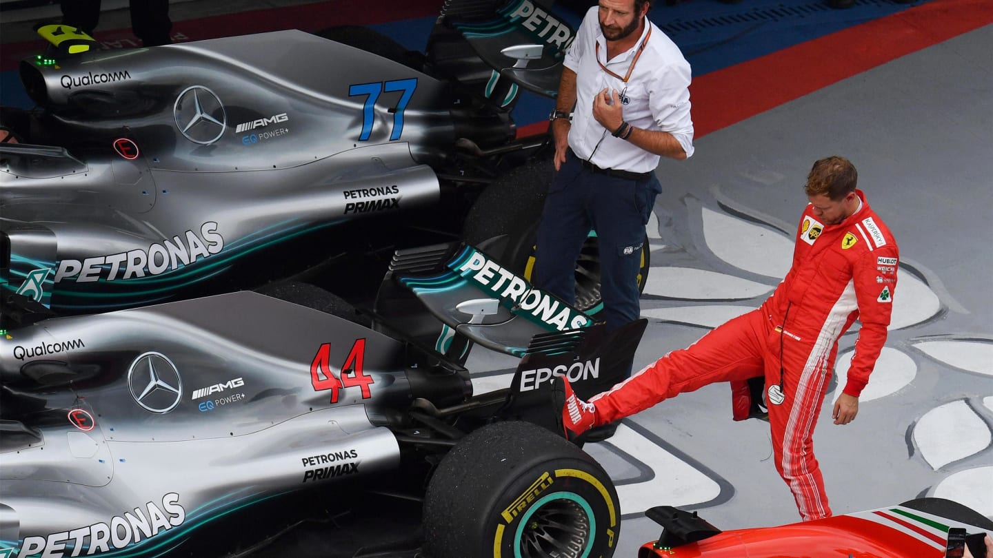 Sebastian Vettel, Ferrari looks at the rear Pirelli tyre of the car of Lewis Hamilton, Mercedes-AMG