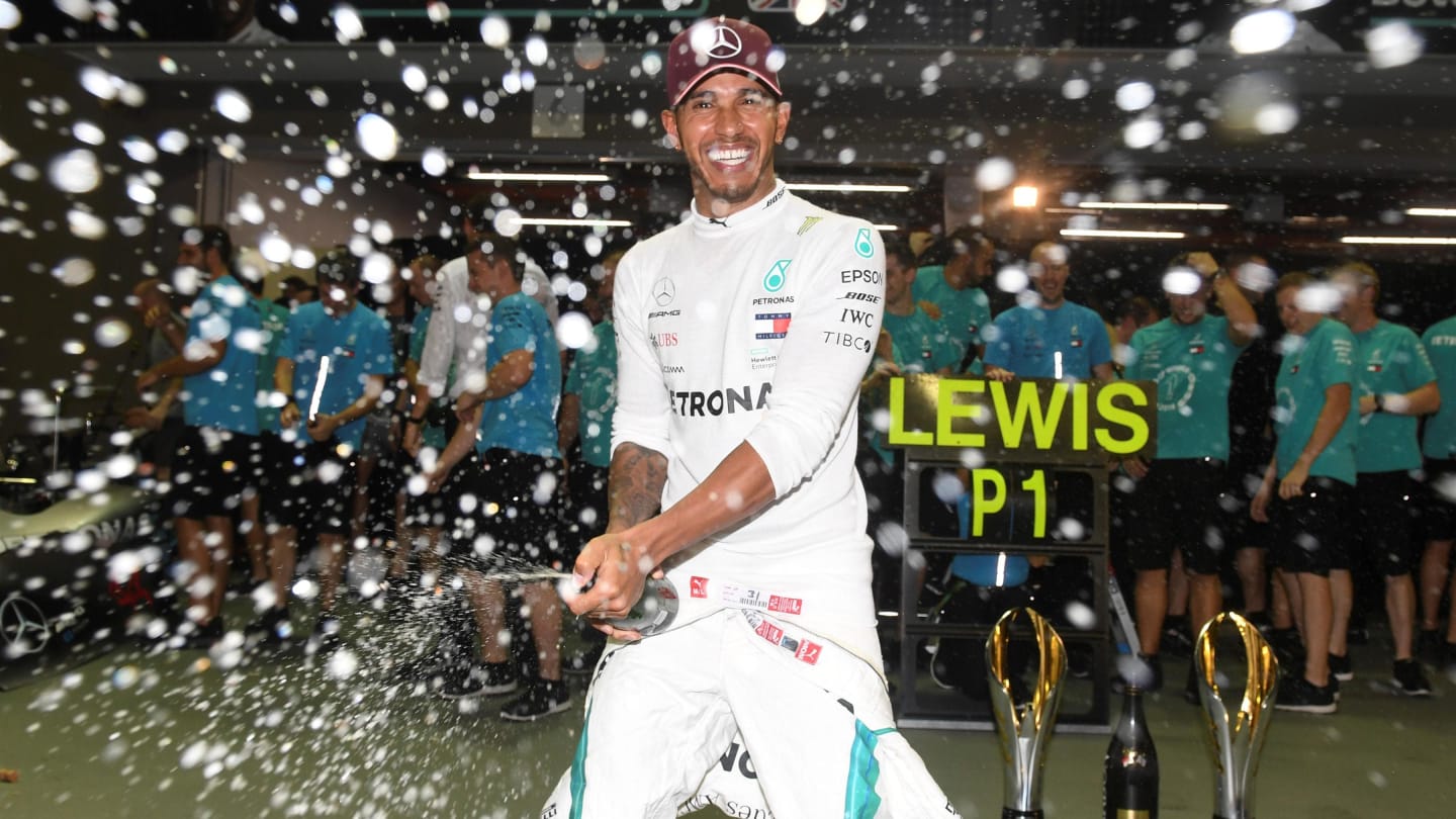 Lewis Hamilton, Mercedes AMG F1 celebrates with the champagne and his team at Formula One World Championship, Rd15, Singapore Grand Prix, Race, Marina Bay Circuit, Singapore, Sunday 16 September 2018.