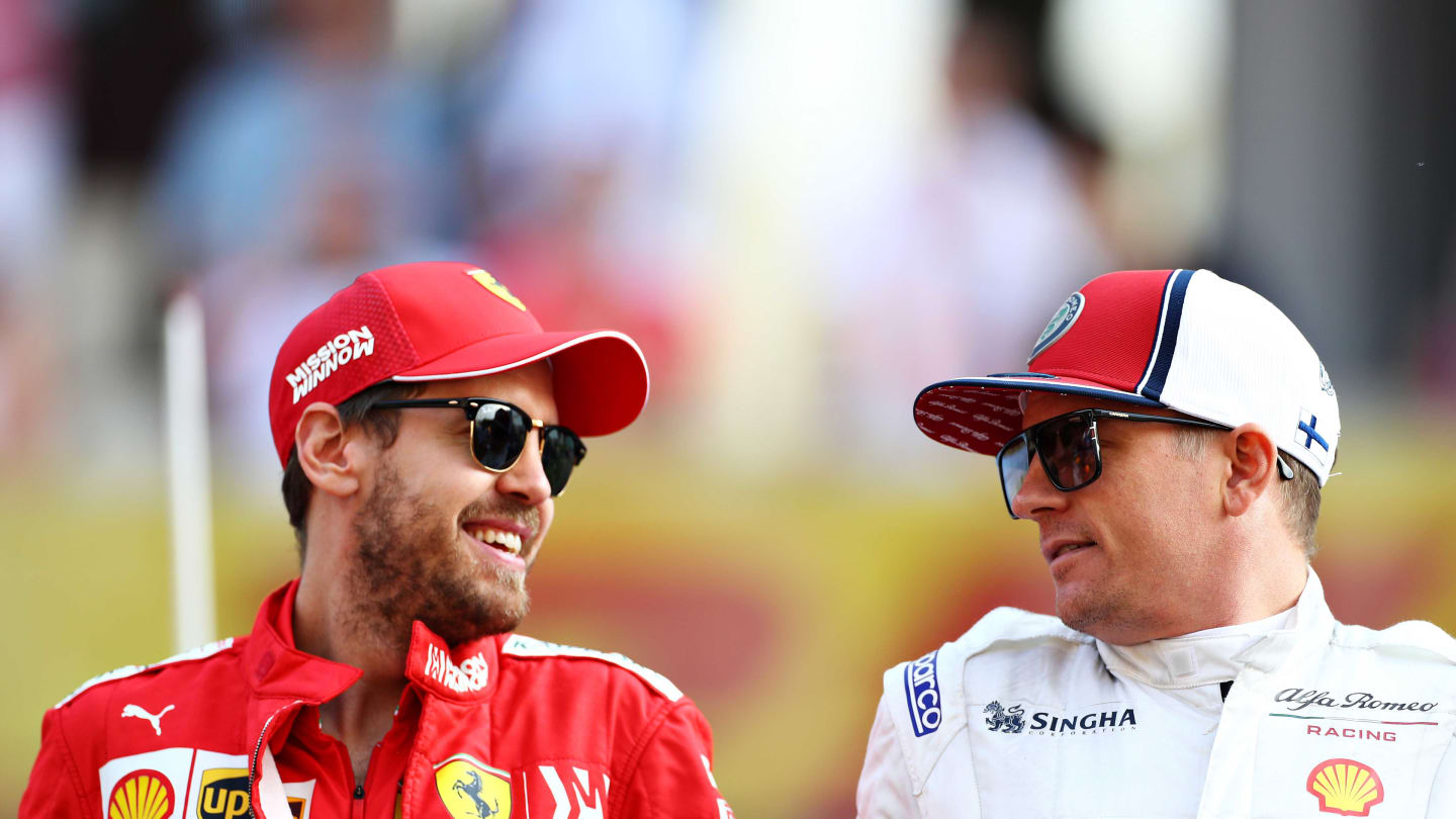 ABU DHABI, UNITED ARAB EMIRATES - DECEMBER 01: Sebastian Vettel of Germany and Ferrari and Kimi