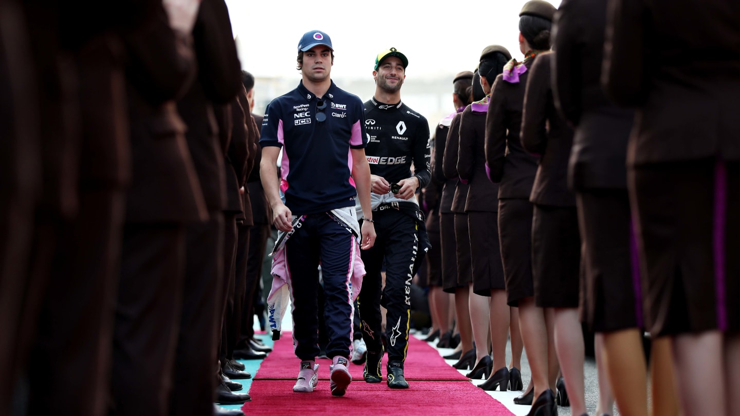 ABU DHABI, UNITED ARAB EMIRATES - DECEMBER 01: Lance Stroll of Canada and Racing Point and Daniel Ricciardo of Australia and Renault Sport F1 walk to the drivers parade before the F1 Grand Prix of Abu Dhabi at Yas Marina Circuit on December 01, 2019 in Abu Dhabi, United Arab Emirates. (Photo by Mark Thompson/Getty Images)