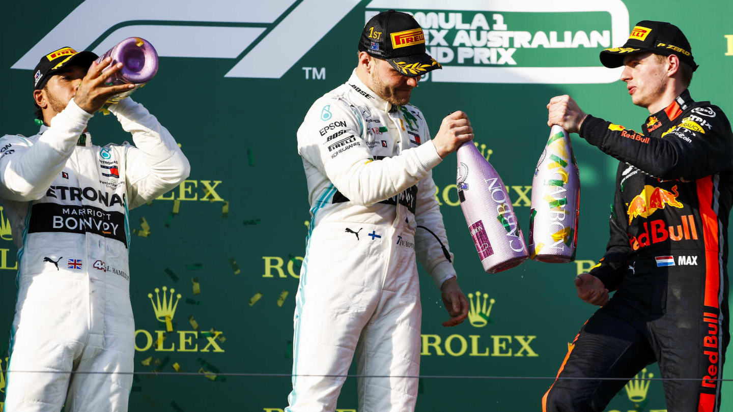 MELBOURNE GRAND PRIX CIRCUIT, AUSTRALIA - MARCH 17: Lewis Hamilton, Mercedes AMG F1, 2nd position, Valtteri Bottas, Mercedes AMG F1, 1st position, and Max Verstappen, Red Bull Racing, 3rd position, celebrate with Champagne on the podium during the Australian GP at Melbourne Grand Prix Circuit on March 17, 2019 in Melbourne Grand Prix Circuit, Australia. (Photo by Glenn Dunbar / LAT Images)