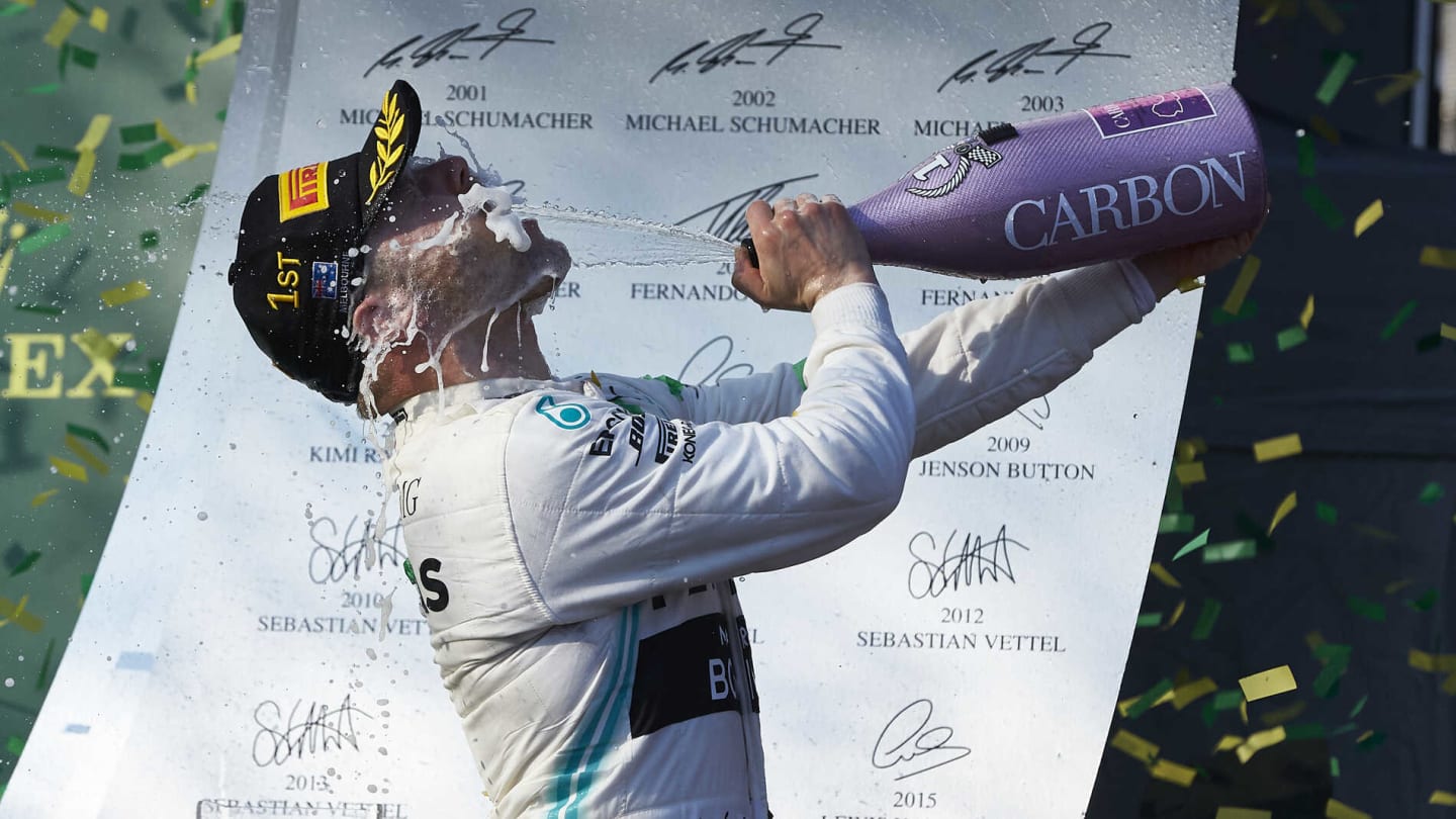 MELBOURNE GRAND PRIX CIRCUIT, AUSTRALIA - MARCH 17: Valtteri Bottas, Mercedes AMG F1, 1st position, sprays the victory Champagne into his face during the Australian GP at Melbourne Grand Prix Circuit on March 17, 2019 in Melbourne Grand Prix Circuit, Australia. (Photo by LAT Images)