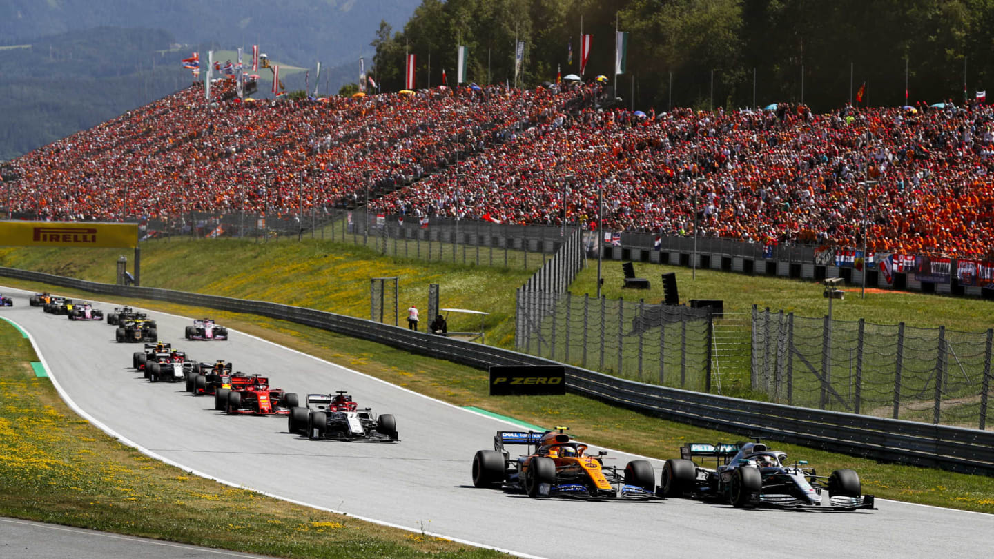 RED BULL RING, AUSTRIA - JUNE 30: Lewis Hamilton, Mercedes AMG F1 W10, leads Lando Norris, McLaren