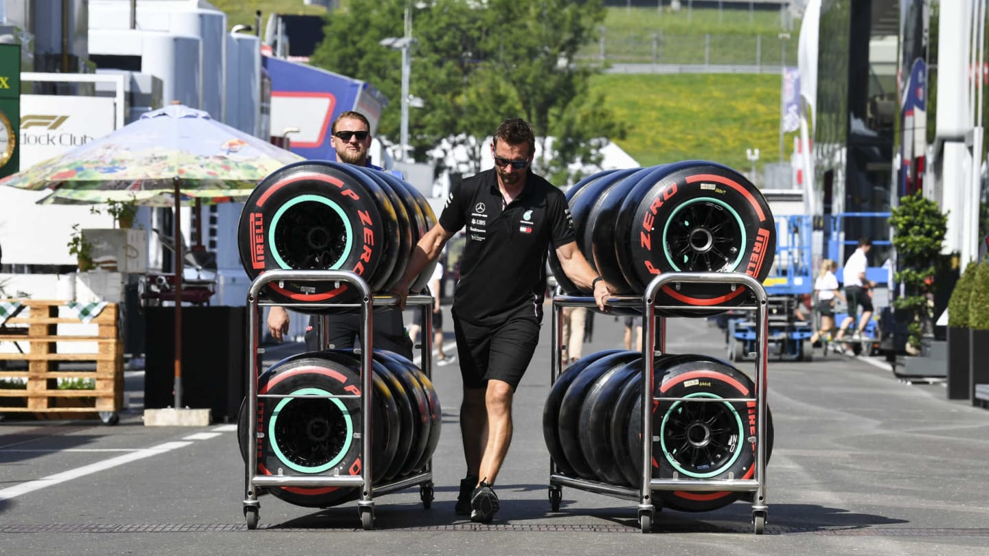 RED BULL RING, AUSTRIA - JUNE 27: Pirelli tyres in the paddock being pushed by a Mercedes Mechanic