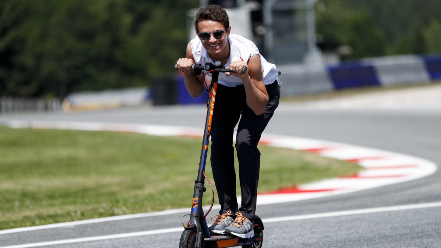 RED BULL RING, AUSTRIA - JUNE 27: Lando Norris, McLaren walks the track on scooters during the