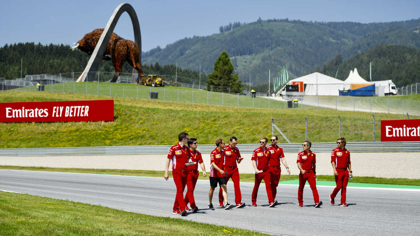 RED BULL RING, AUSTRIA - JUNE 27: Sebastian Vettel, Ferrari walks the track with his team during