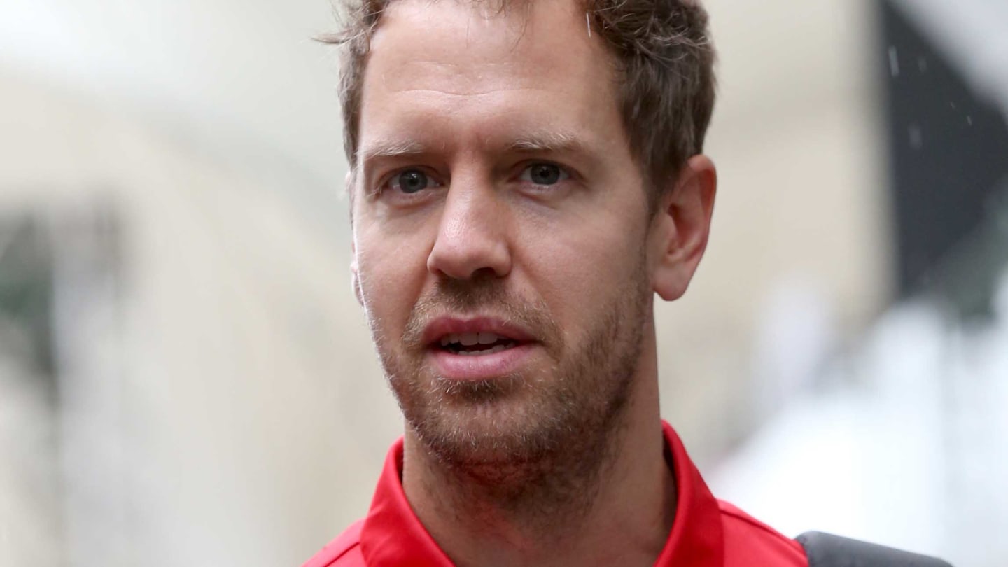 SAO PAULO, BRAZIL - NOVEMBER 15: Sebastian Vettel of Germany and Ferrari walks in the Paddock