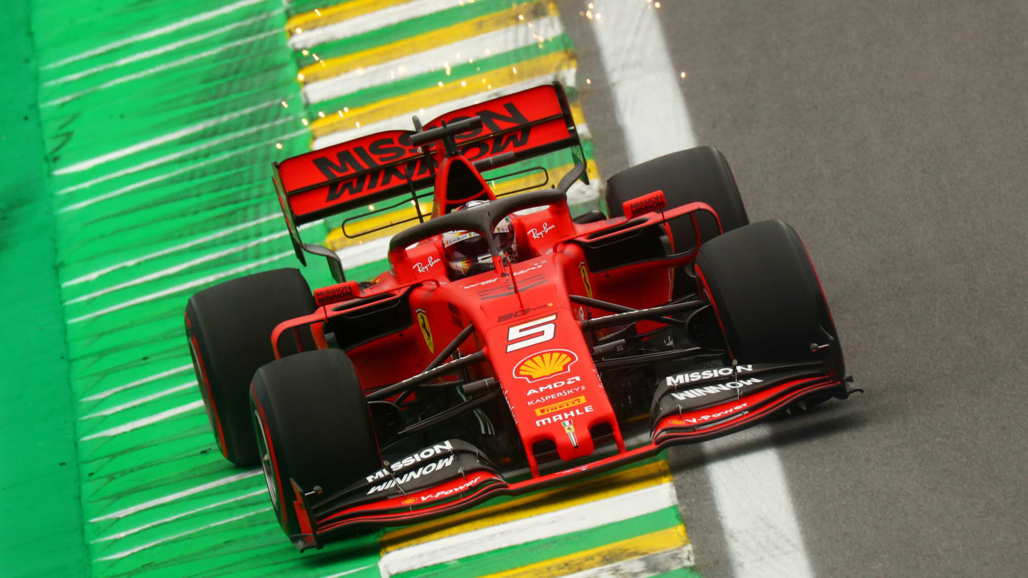 SAO PAULO, BRAZIL - NOVEMBER 15: Sparks fly behind Sebastian Vettel of Germany driving the (5)
