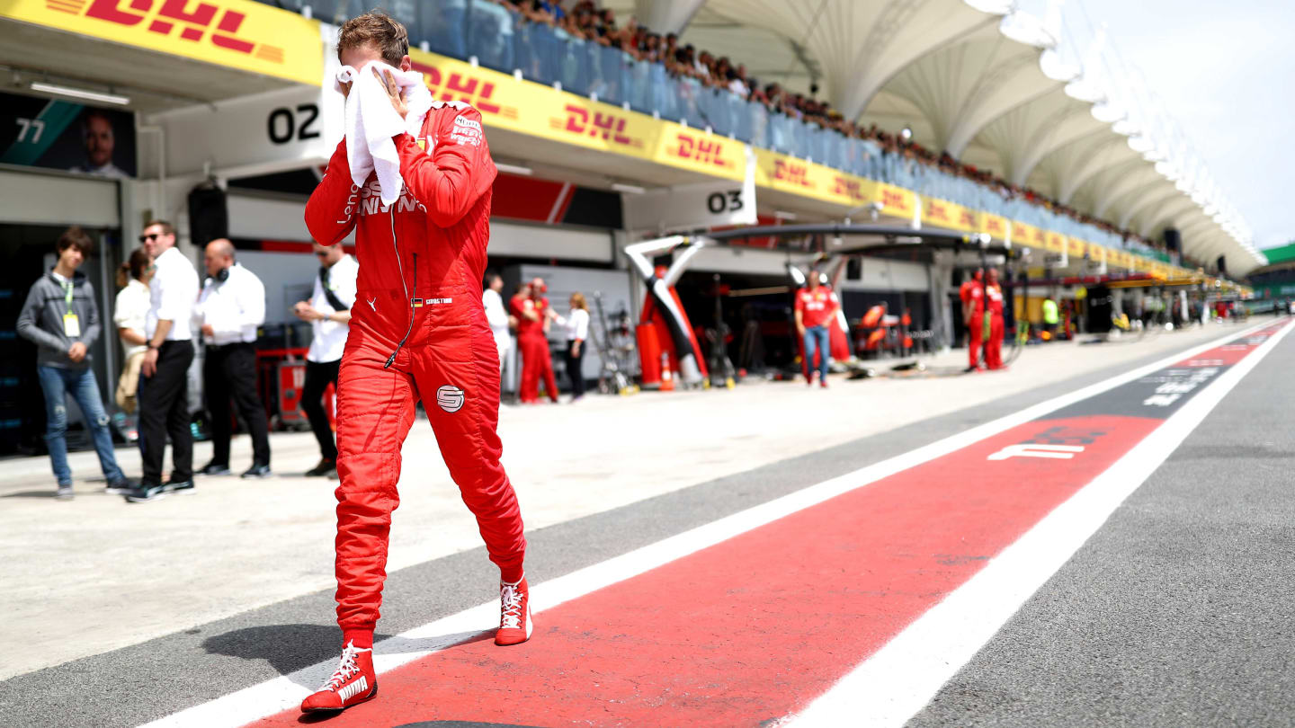 SAO PAULO, BRAZIL - NOVEMBER 17: Sebastian Vettel of Germany and Ferrari walks to the grid before