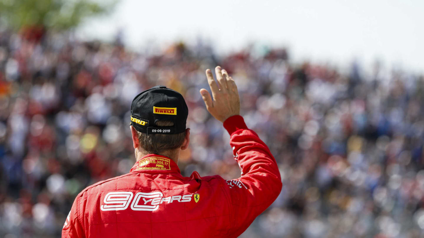 CIRCUIT GILLES-VILLENEUVE, CANADA - JUNE 09: Sebastian Vettel, Ferrari waves to fans on the podium