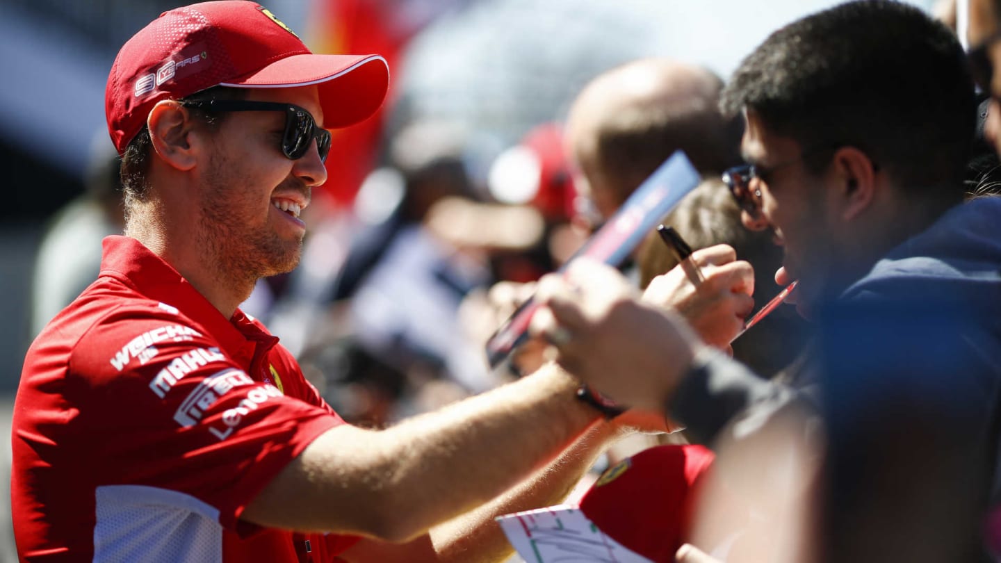 CIRCUIT GILLES-VILLENEUVE, CANADA - JUNE 06: Sebastian Vettel, Ferrari signs a autograph for a fan
