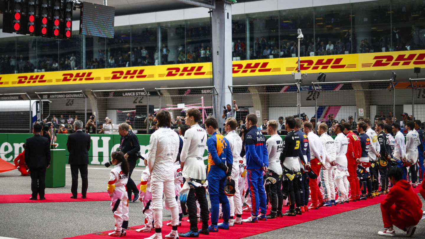 SHANGHAI INTERNATIONAL CIRCUIT, CHINA - APRIL 14: The drivers stand for the national anthem prior