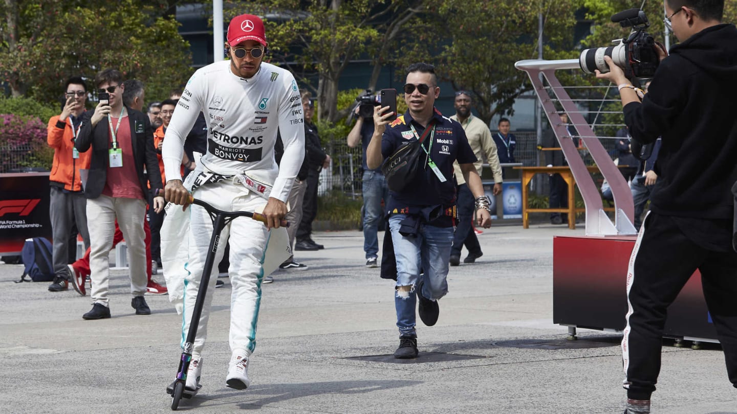 SHANGHAI INTERNATIONAL CIRCUIT, CHINA - APRIL 13: Lewis Hamilton, Mercedes AMG F1, on his scooter