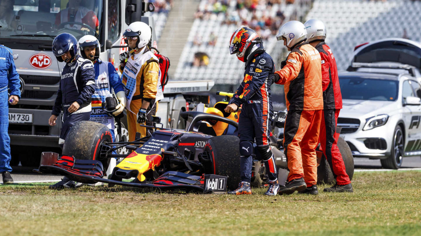 HOCKENHEIMRING, GERMANY - JULY 26: Marshals and doctors assist Pierre Gasly, Red Bull Racing RB15,