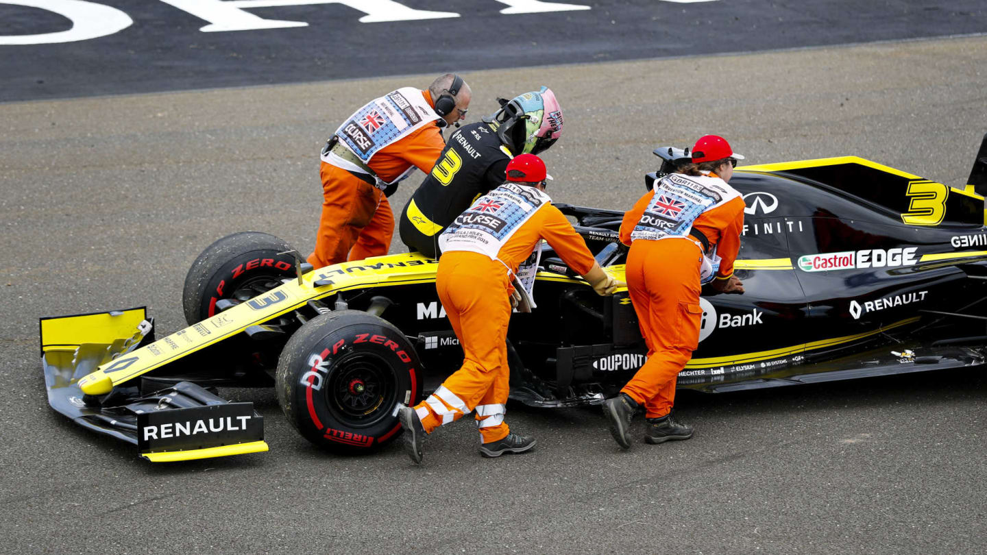 SILVERSTONE, UNITED KINGDOM - JULY 12: Marshals assist Daniel Ricciardo, Renault R.S.19, after car