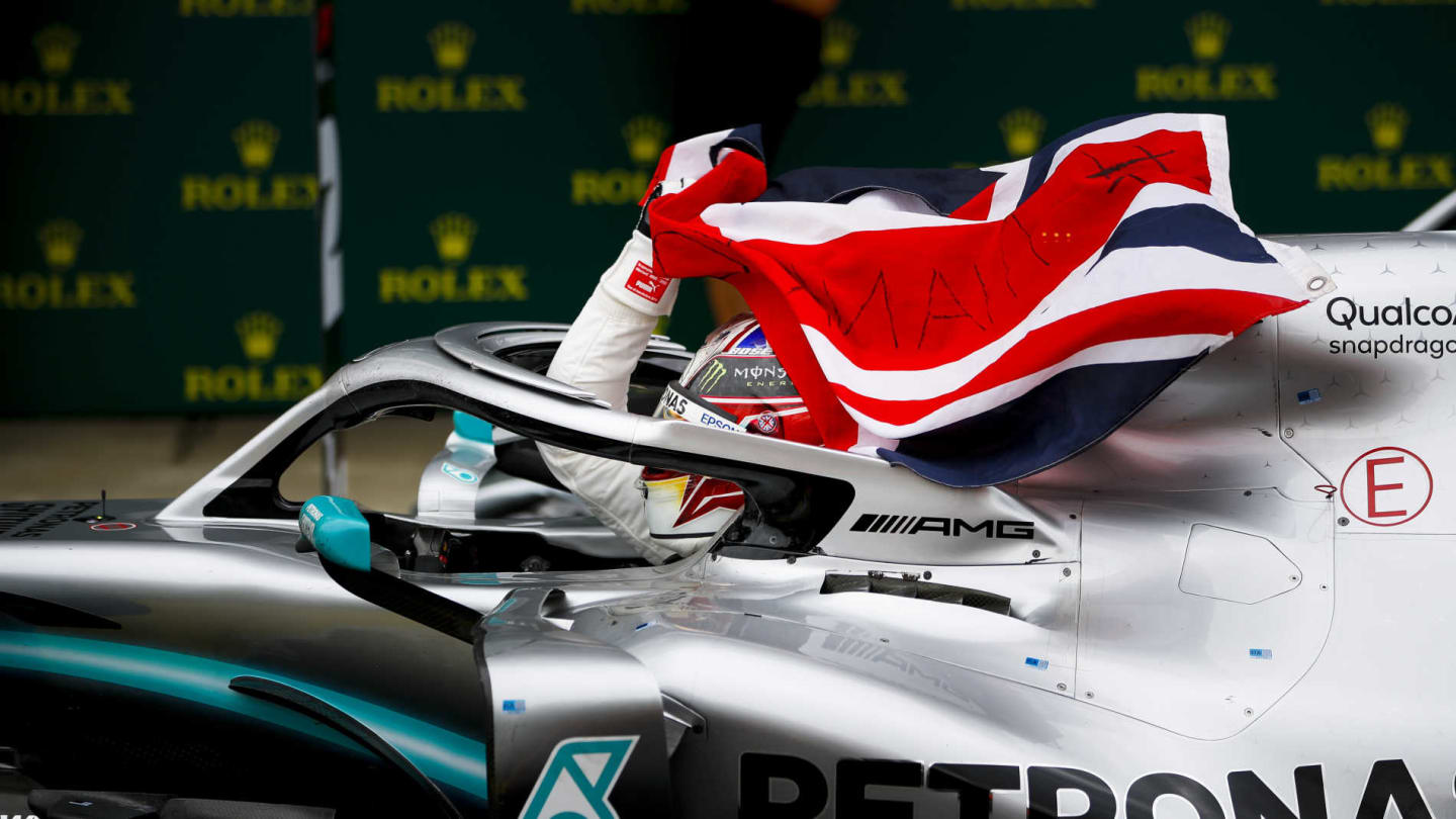 SILVERSTONE, UNITED KINGDOM - JULY 14: Race winner Lewis Hamilton, Mercedes AMG F1 W10 with a flag