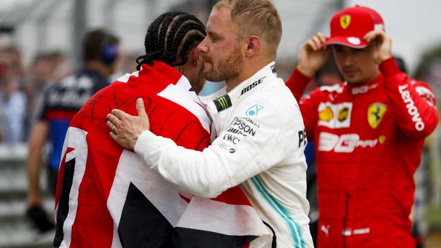 SILVERSTONE, UNITED KINGDOM - JULY 14: Race winner Lewis Hamilton, Mercedes AMG F1 and Valtteri Bottas, Mercedes AMG F1 celebrate in Parc Ferme during the British GP at Silverstone on July 14, 2019 in Silverstone, United Kingdom. (Photo by Zak Mauger / LAT Images)