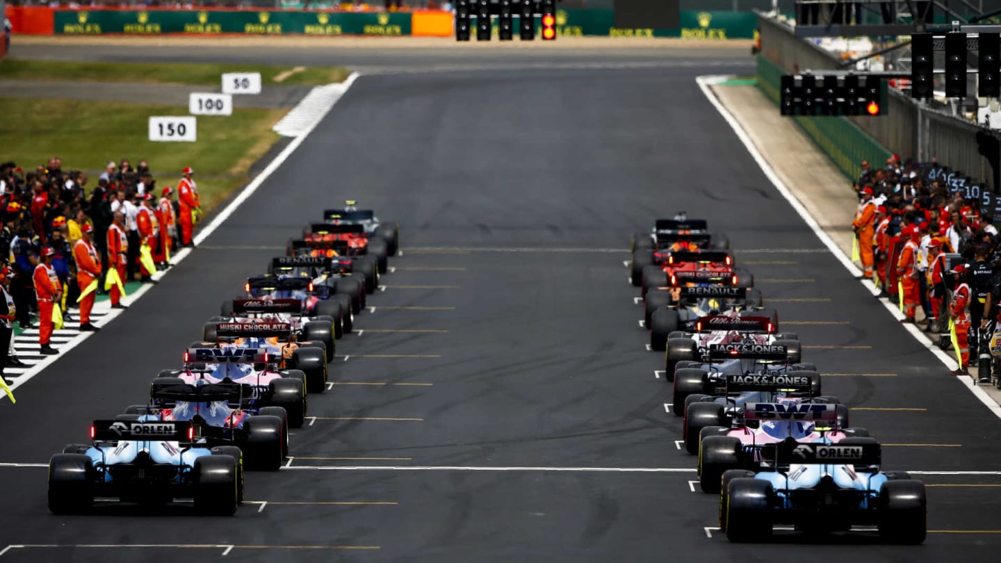 SILVERSTONE, UNITED KINGDOM - JULY 14: Mechanics clear the grid as the drivers prepare to head off