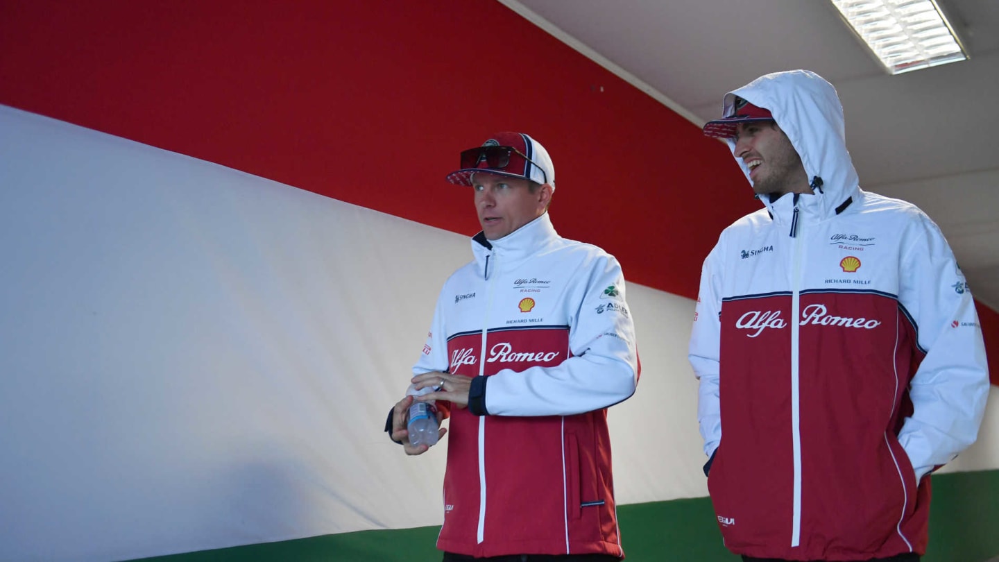 HUNGARORING, HUNGARY - AUGUST 02: Kimi Raikkonen, Alfa Romeo Racing, and Antonio Giovinazzi, Alfa