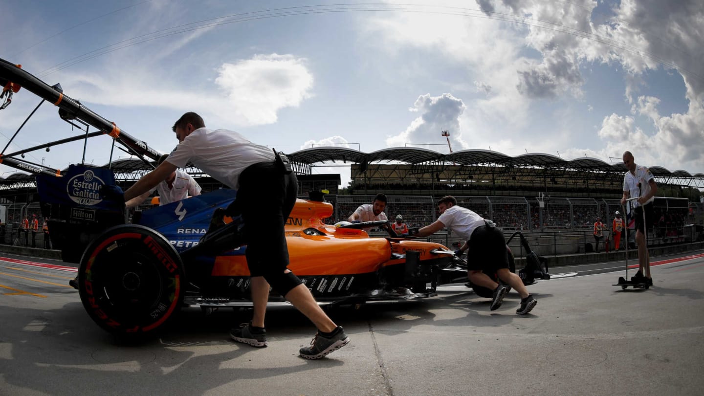 HUNGARORING, HUNGARY - AUGUST 03: Lando Norris, McLaren MCL34, is returned to the garage during the