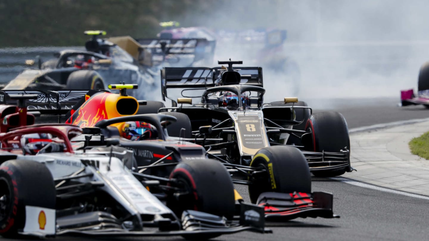 HUNGARORING, HUNGARY - AUGUST 04: Kimi Raikkonen, Alfa Romeo Racing C38, battles with Pierre Gasly, Red Bull Racing RB15, and Romain Grosjean, Haas VF-19, at the start during the Hungarian GP at Hungaroring on August 04, 2019 in Hungaroring, Hungary. (Photo by Steven Tee / LAT Images)