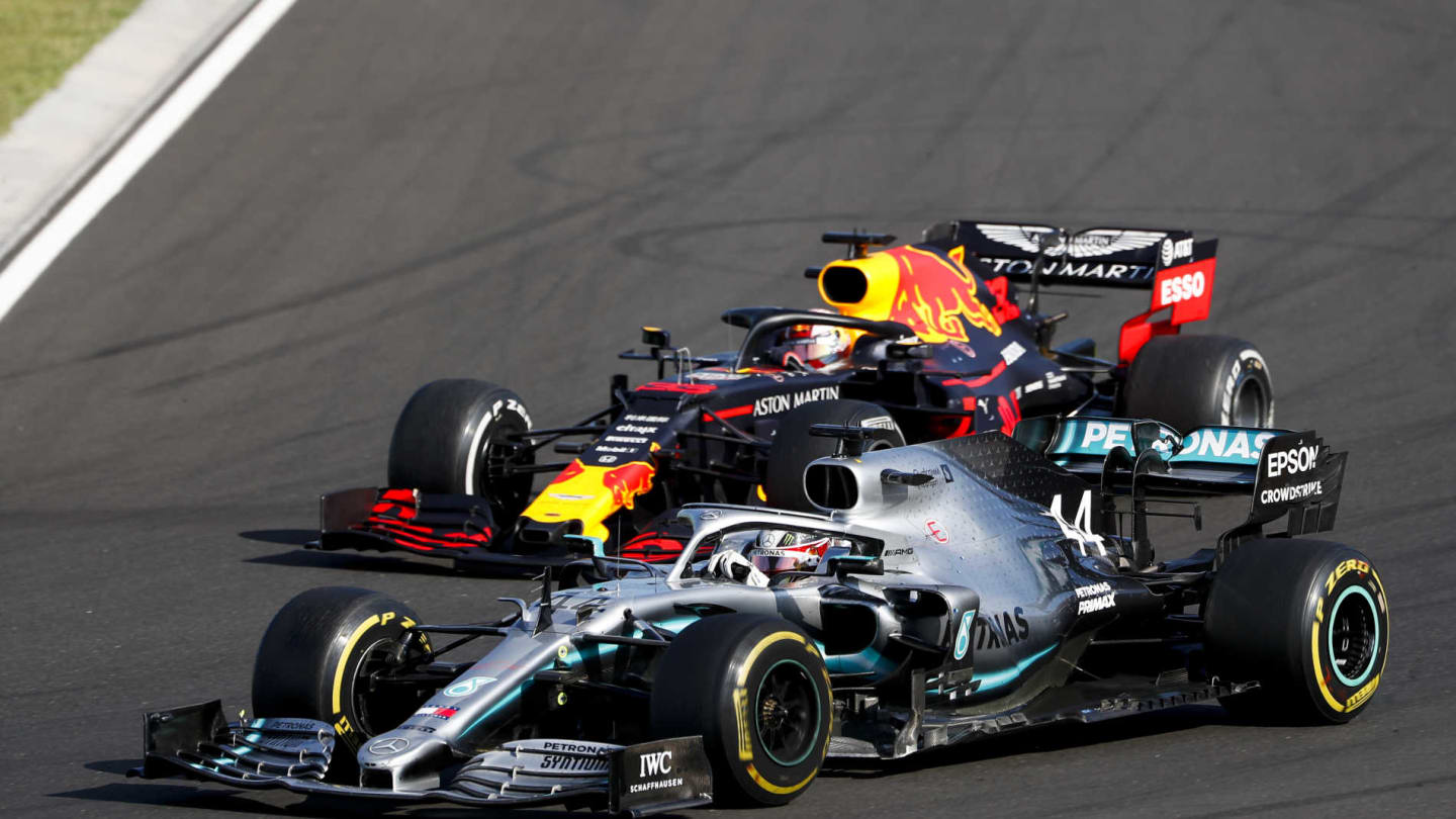 HUNGARORING, HUNGARY - AUGUST 04: Lewis Hamilton, Mercedes AMG F1 W10 overtakes Max Verstappen, Red