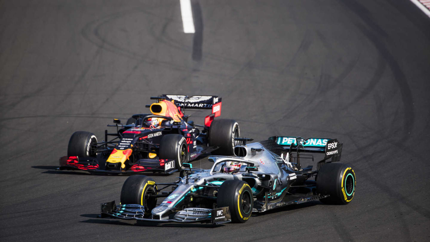 HUNGARORING, HUNGARY - AUGUST 04: Lewis Hamilton, Mercedes AMG F1 W10, passes Max Verstappen, Red Bull Racing RB15, for the lead during the Hungarian GP at Hungaroring on August 04, 2019 in Hungaroring, Hungary. (Photo by Sam Bloxham / LAT Images)