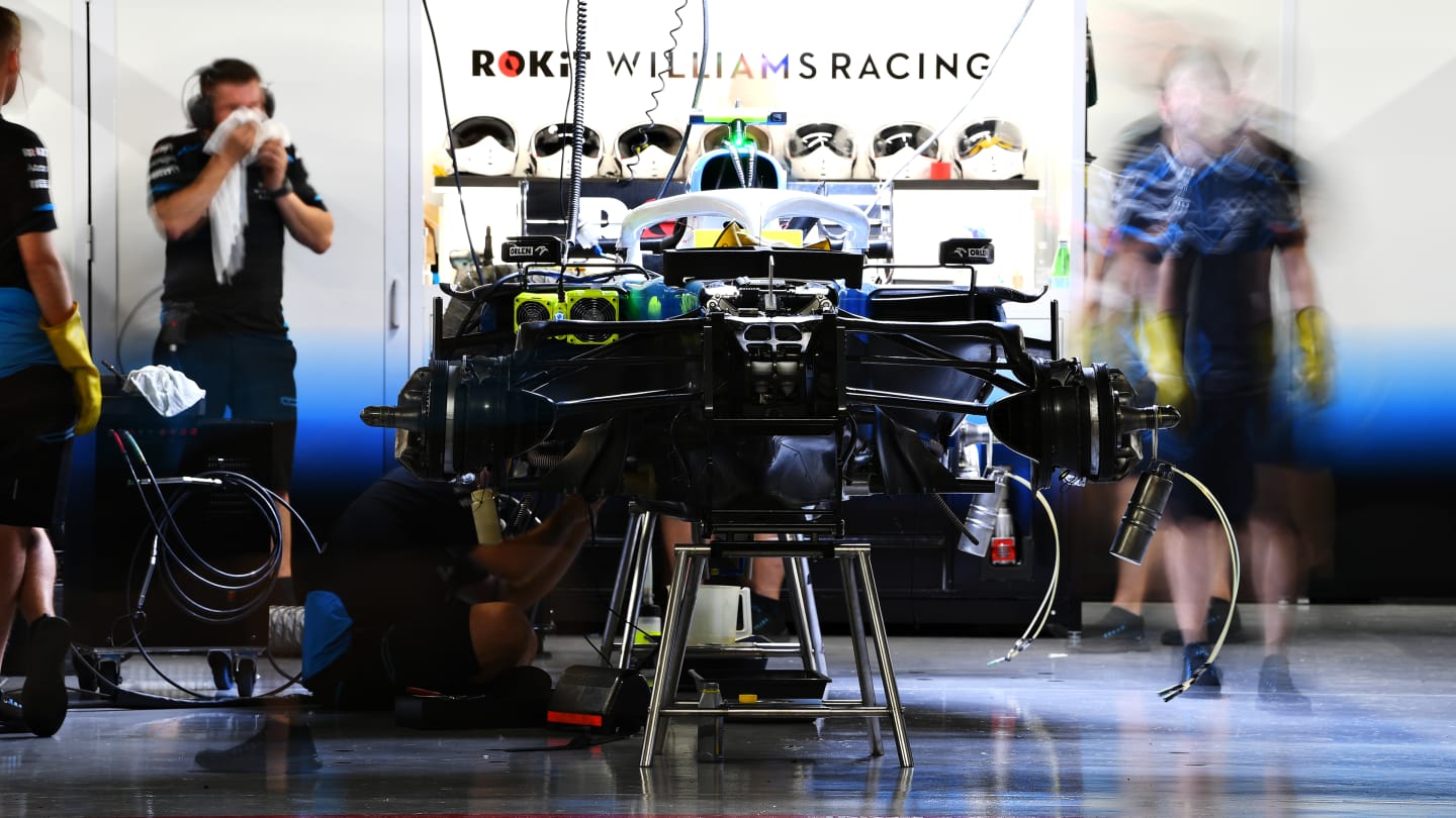 SUZUKA, JAPAN - OCTOBER 11: The Williams team work in the garage after practice for the F1 Grand