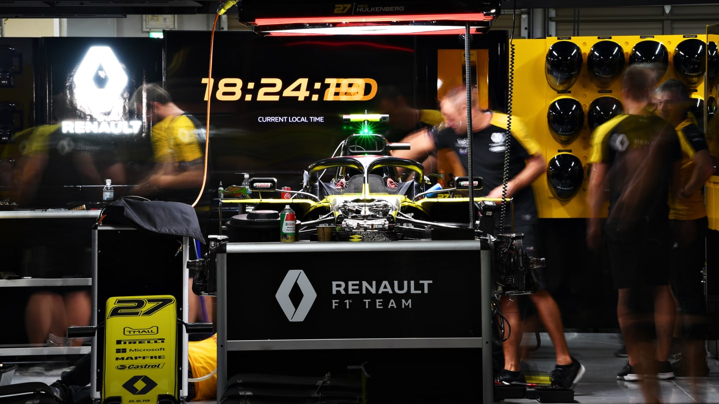 SUZUKA, JAPAN - OCTOBER 11: The Renault Sport F1 team work in the garage after practice for the F1