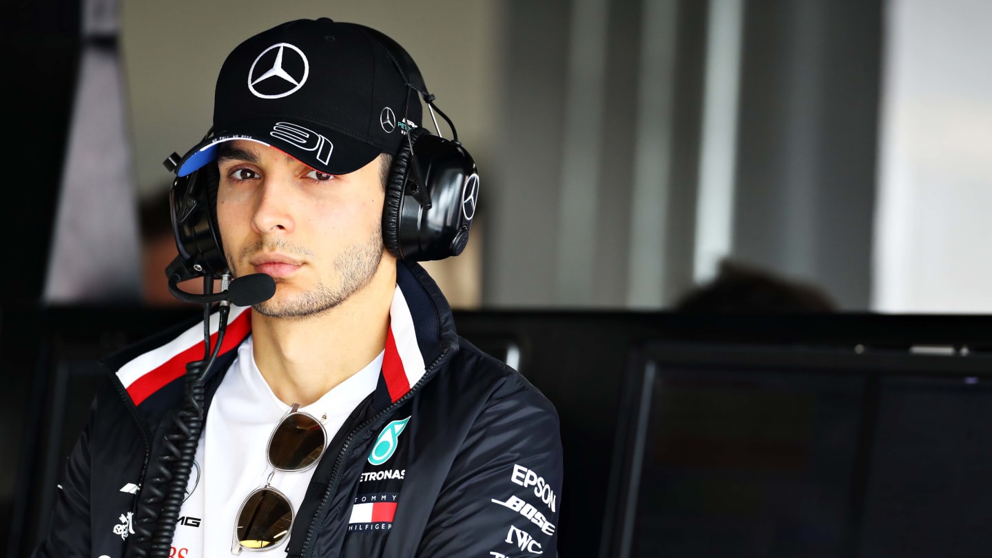 SUZUKA, JAPAN - OCTOBER 11: Esteban Ocon of France and Mercedes GP looks on in the garage during