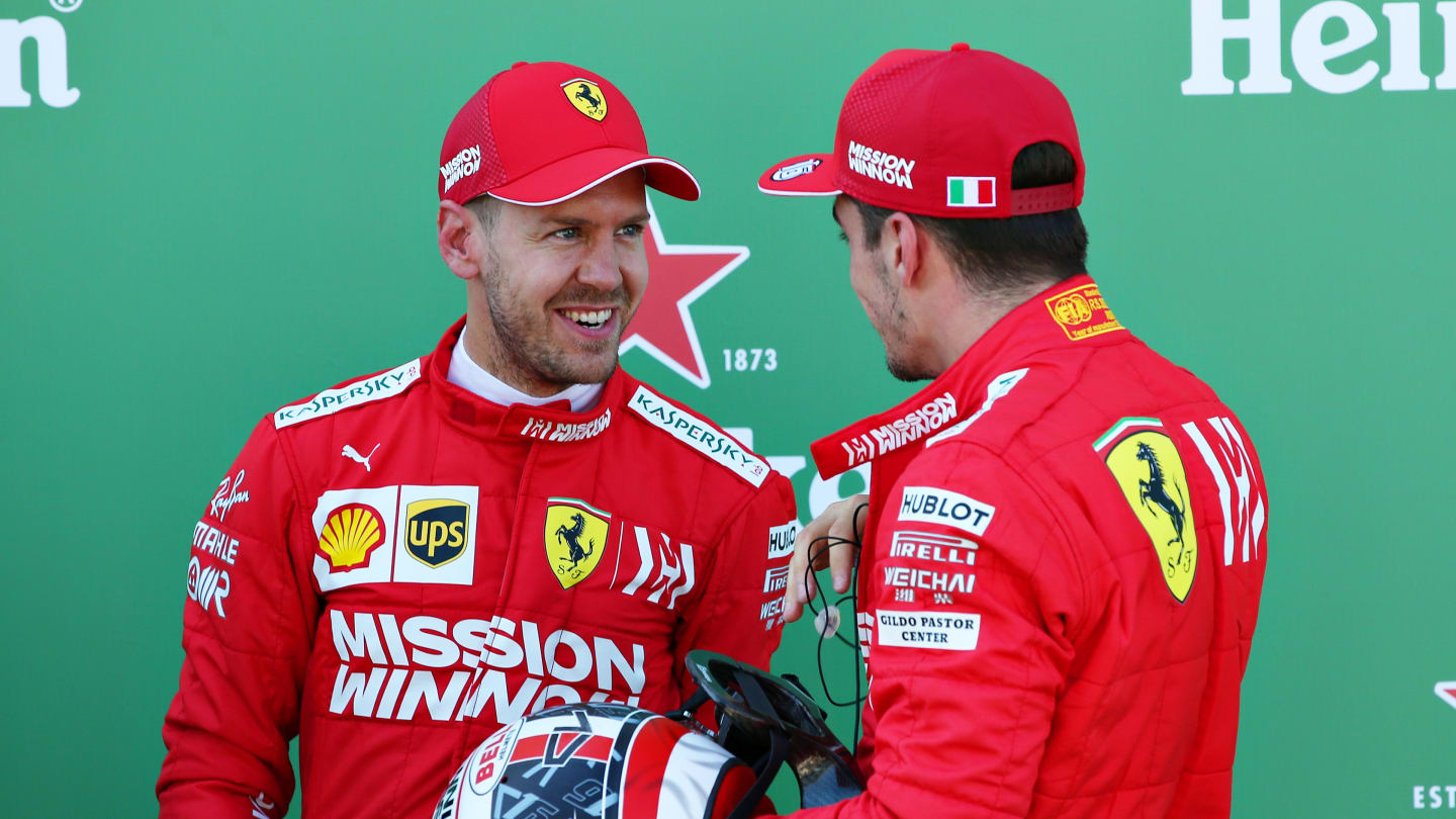 SUZUKA, JAPAN - OCTOBER 13: Top two qualifiers Sebastian Vettel of Germany and Ferrari and Charles